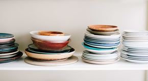Bellingham apartment for rent - a stack of plates and bowls on a shelf