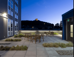 Seattle apartment for rent - A patio with a table and chairs is lit up at night.