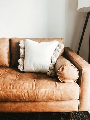 Ferndale apartment for rent - a brown leather couch with a white pillow on it