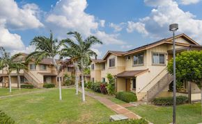 Kapolei apartment for rent - a row of houses with palm trees and a sidewalk