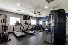 Vernal apartment for rent - A gym with treadmills, elliptical machines, and a weight machine.