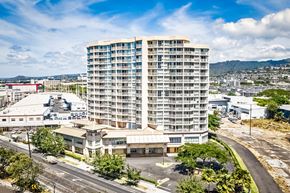 Honolulu apartment for rent - an aerial view of a tall building in the middle of a city
