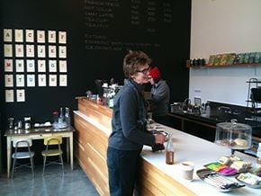 Seattle apartment for rent - A woman is standing behind a counter in a coffee shop.