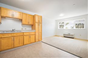 Kapolei apartment for rent - an empty kitchen with wooden cabinets and a sink