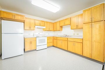 Kapolei apartment for rent - a large kitchen with white appliances and wooden cabinets