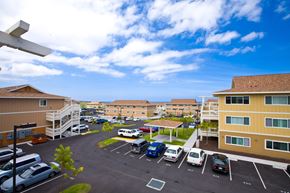 Kailua-Kona apartment for rent - an aerial view of a parking lot with cars and buildings