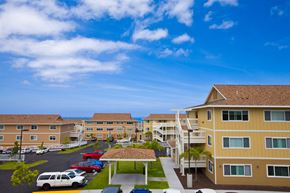 Kailua-Kona apartment for rent - a large building with cars parked in front of it
