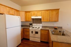 Kailua-Kona apartment for rent - a kitchen with white appliances and wooden cabinets