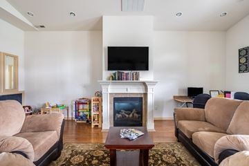 Ellensburg apartment for rent - a living room with couches and a fireplace and a television