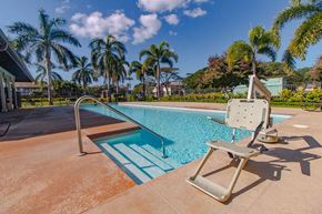 Ewa Beach apartment for rent - a swimming pool with a chair next to it