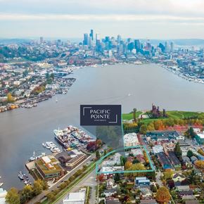 Seattle townhouse for rent - An aerial view of a city with a body of water and a sign that says Pacific Pointe Apartments.