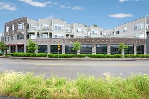 Seattle townhouse for rent - A row of modern buildings with a yellow pedestrian crossing sign in front.