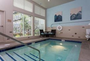 Everett apartment for rent - a swimming pool in a room with a large window
