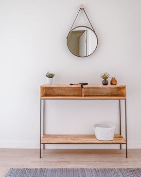 Bellingham apartment for rent - a vanity with a mirror and a basket on the floor
