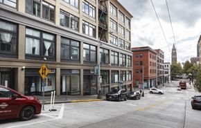 Seattle apartment for rent - A city street with cars and buildings.