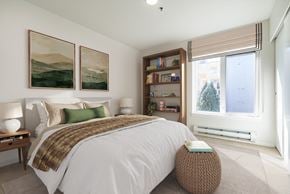 Seattle apartment for rent - A bedroom with a large bed and two landscape paintings on the wall.