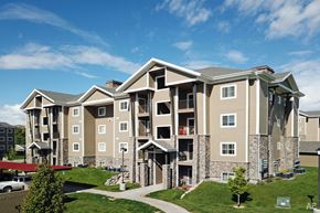 Vernal apartment for rent - an exterior view of an apartment building on a sunny day