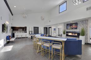 Denver apartment for rent - A modern dining area with a long table and chairs.