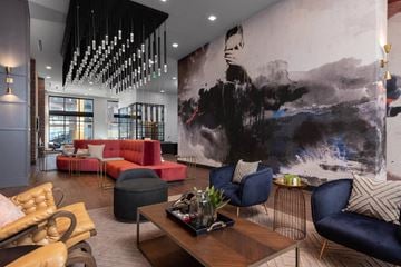 Denver apartment for rent - A modern living room with a large abstract painting on the wall.