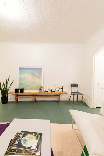 Detroit apartment for rent - a living room with white furniture and a painting on the wall