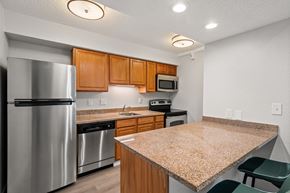 Madison Heights apartment for rent - A kitchen with a granite counter top and stainless steel appliances.