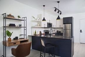 Detroit apartment for rent - a kitchen and dining area with a black counter top