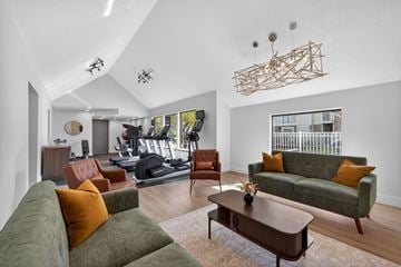 Madison Heights apartment for rent - A living room with a green couch and a wooden coffee table.