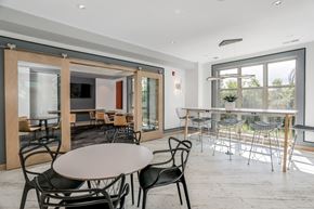 West Bloomfield apartment for rent - a dining room with tables and chairs and a large window