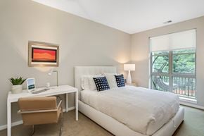 West Bloomfield apartment for rent - a bedroom with a bed and a desk and a window