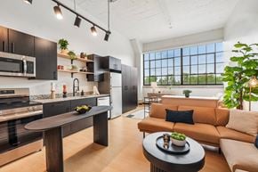 Detroit apartment for rent - A modern kitchen with a dining table and a couch.