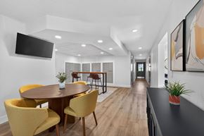 Madison Heights apartment for rent - A modern dining room with a round table and yellow chairs.