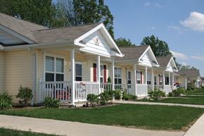 Norwalk apartment for rent - a row of houses in a neighborhood with a sidewalk and grass