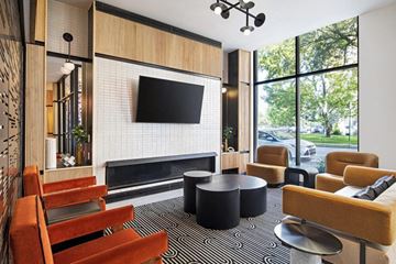 Detroit apartment for rent - a living room with a fireplace and a television