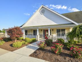 Toledo apartment for rent - A white house with a red door and a small porch.