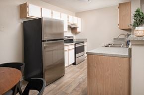 Jackson apartment for rent - a kitchen with white cabinets and stainless steel appliances
