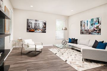 Jackson apartment for rent - a living room with a white couch and a glass table