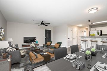 North Little Rock apartment for rent - A modern living room with a grey sofa set and a black and white checkered ottoman.