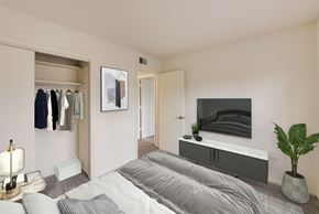 Columbus townhouse for rent - A bedroom with a large bed and a TV on the wall.