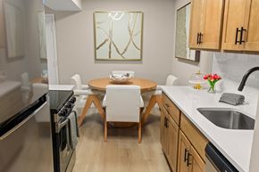 Battle Creek apartment for rent - A modern kitchen with a wooden table and chairs.