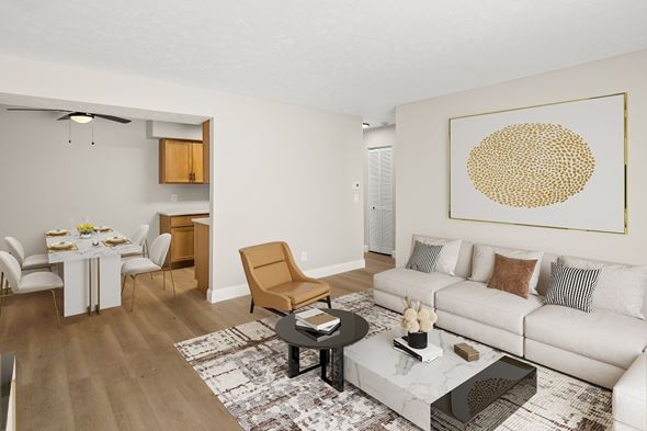Battle Creek apartment for rent - A living room with a white couch and a large painting on the wall.