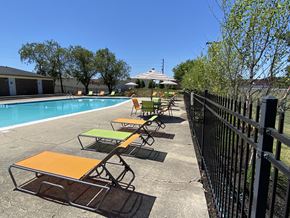 Indianapolis apartment for rent - a row of lounge chairs next to a swimming pool