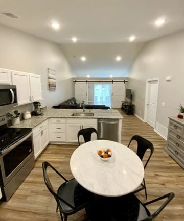 Howell apartment for rent - A kitchen with a table and chairs in the foreground and a living room in the background.