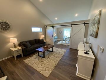 Howell apartment for rent - A living room with a brown couch and a rug.