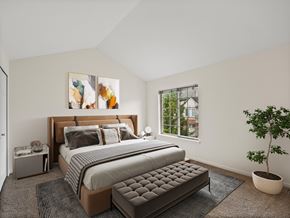 Novi apartment for rent - A bedroom with a large bed and a potted plant.