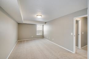 Mount Pleasant apartment for rent - A spacious room with a carpeted floor and a window.