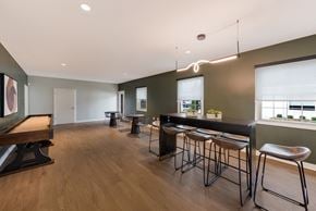 Columbus townhouse for rent - A modern bar area with a pool table and stools.