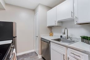 Ridgeland apartment for rent - a kitchen with white cabinets and stainless steel appliances and a sink