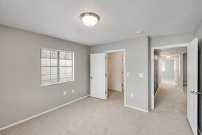 Mount Pleasant apartment for rent - A spacious room with a carpeted floor and a window with blinds.