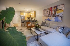 Detroit apartment for rent - A living room with a white couch and a painting on the wall.