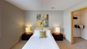 Mount Pleasant apartment for rent - A bedroom with a large bed and two lamps on side tables.